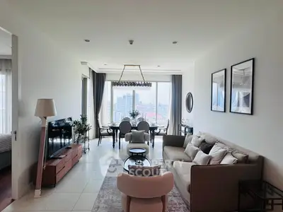 Luxurious living room with stunning city view, elegant decor, and modern furniture in a high-rise apartment.