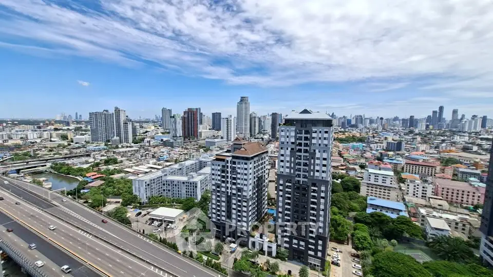 Stunning cityscape view with modern high-rise buildings and clear blue sky, perfect for urban living.