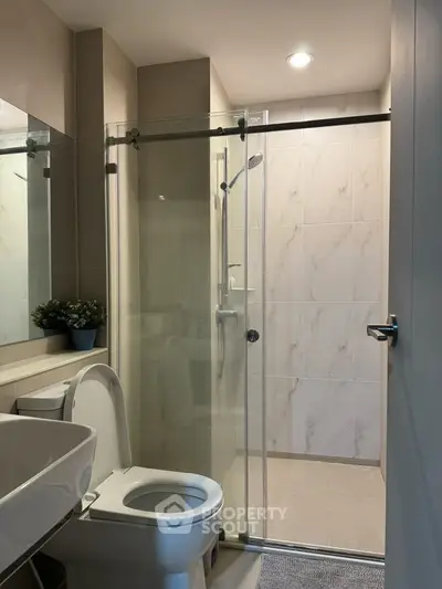Modern bathroom with glass shower and sleek fixtures