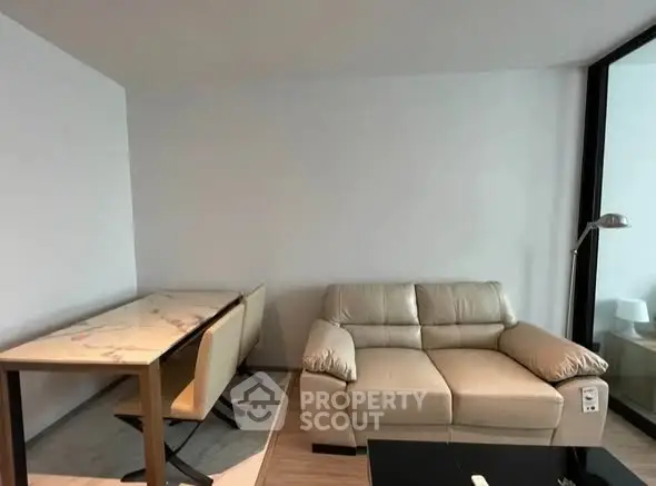 Modern living room with sleek sofa and dining table, perfect for urban living.