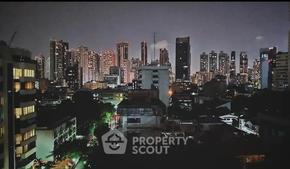 Stunning city skyline view with illuminated skyscrapers at night, perfect for urban living enthusiasts.