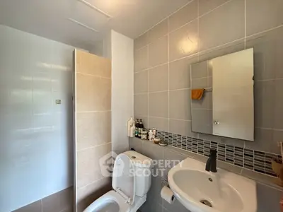 Modern bathroom with sleek fixtures and neutral tile design.