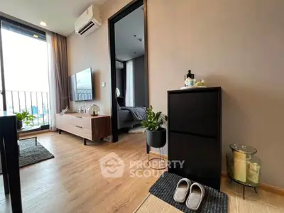 Modern apartment interior with stylish living room and bedroom, featuring wooden flooring and balcony access.