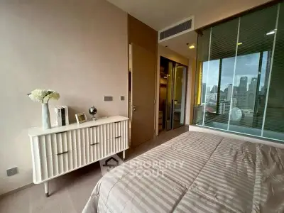 Modern bedroom with city view, featuring stylish decor and ample natural light.