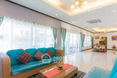 Spacious living room with modern decor and large windows for natural light.