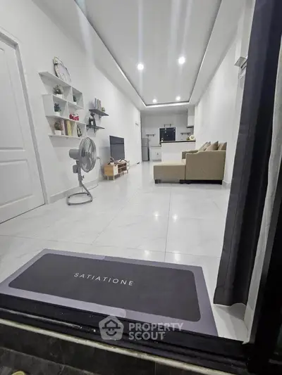 Modern open-layout living room with sleek design and cozy seating area.