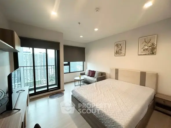 Modern bedroom with city view and cozy decor in high-rise apartment