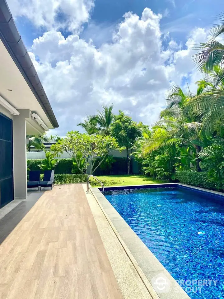 Luxurious villa with private pool and lush garden, perfect for tropical living.