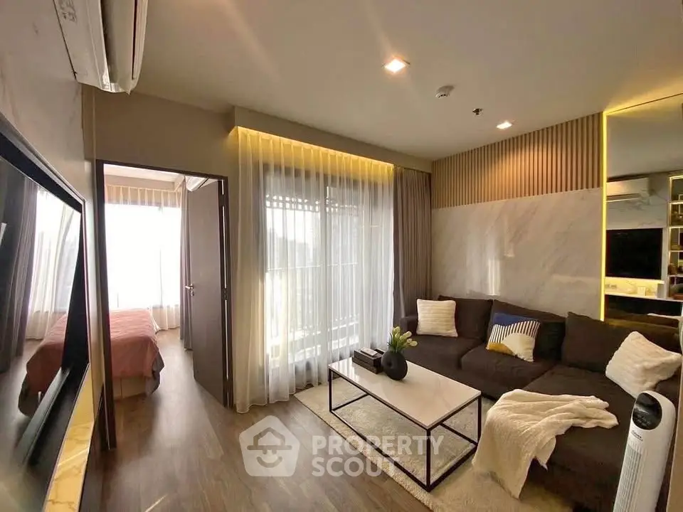 Modern living room with cozy decor and natural light, featuring a stylish sofa and elegant curtains.