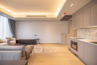 Spacious modern living room with open kitchen and elegant lighting