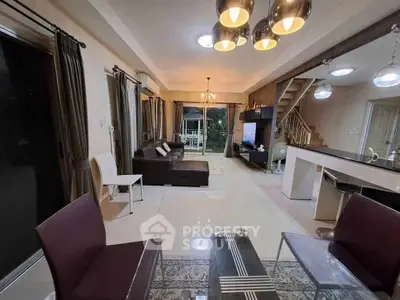 Spacious modern living room with stylish lighting and open layout, perfect for entertaining.