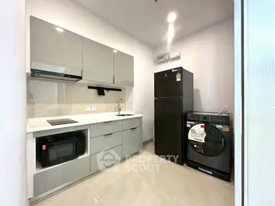 Modern kitchen with sleek cabinetry, appliances, and minimalist design