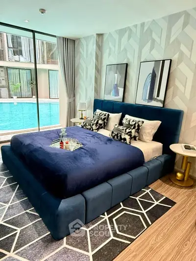 Luxurious bedroom with pool view, featuring elegant decor and modern furnishings for ultimate comfort.