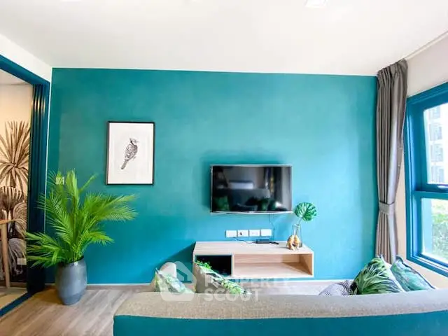 Stylish living room with teal accent wall, modern decor, and natural light.