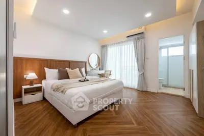 Spacious modern bedroom with elegant decor and natural light