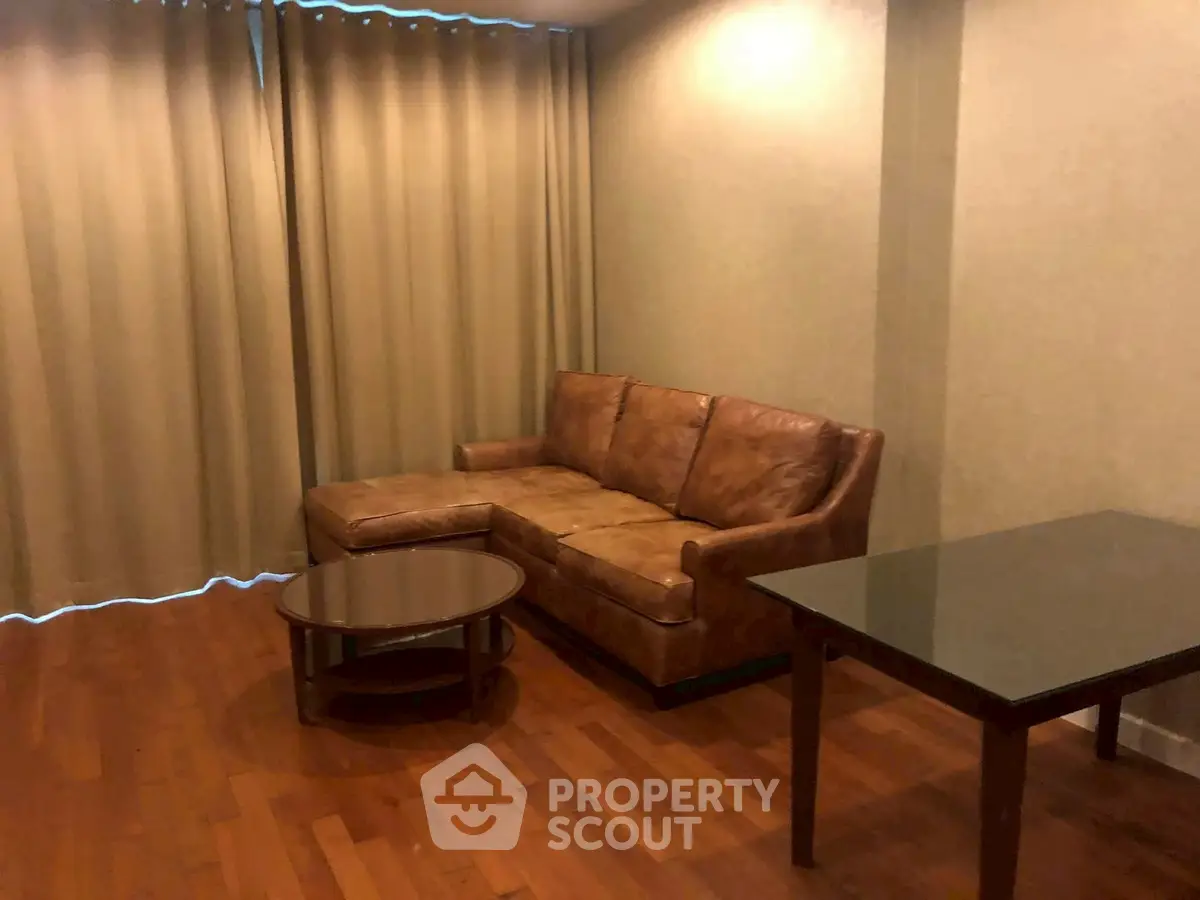 Cozy living room with leather sofa and wooden flooring