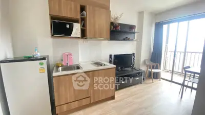 Modern compact kitchen with balcony view in cozy apartment