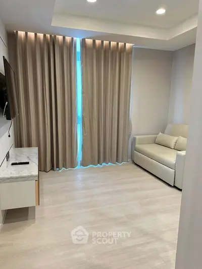 Modern living room with sleek design and cozy sofa, perfect for relaxation.