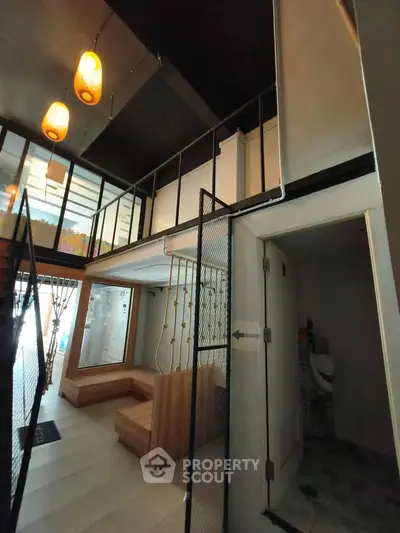 Modern loft-style interior with mezzanine and stylish lighting