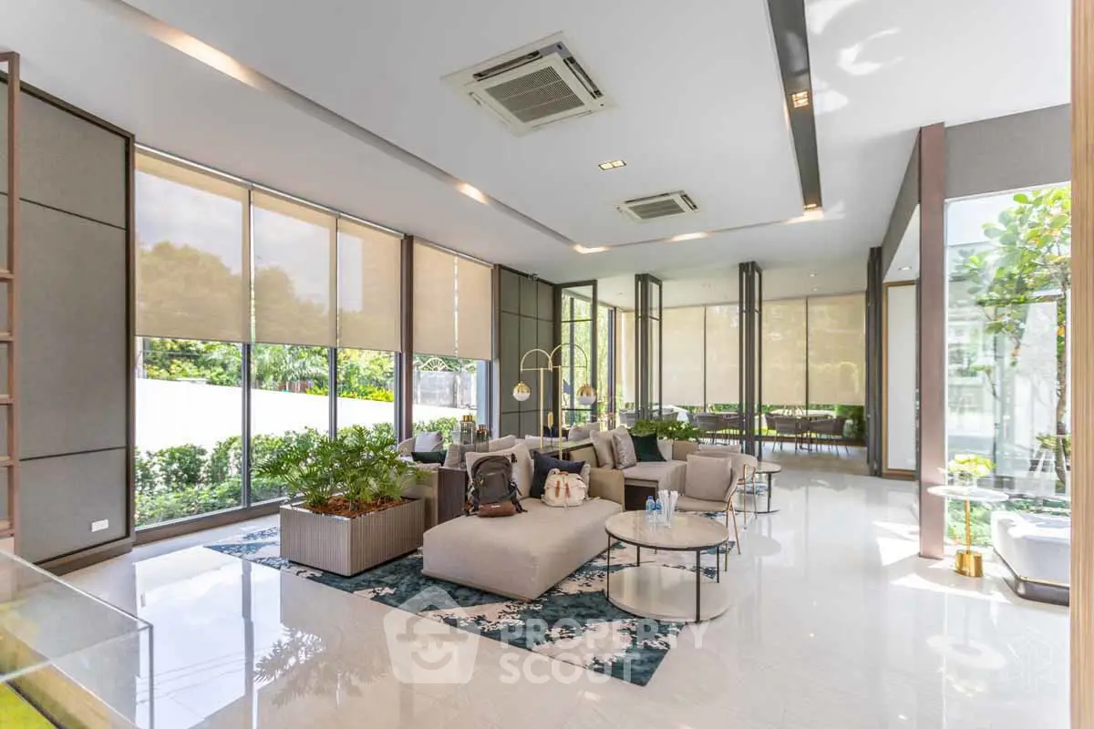 Luxurious modern living room with large windows and stylish furniture, offering a bright and inviting atmosphere.