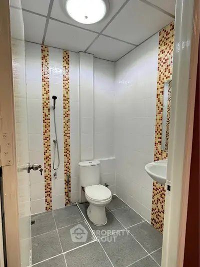 Modern bathroom with stylish tile accents and sleek fixtures, perfect for a contemporary home.