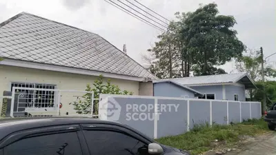 Charming suburban house with fenced yard and modern roof design.