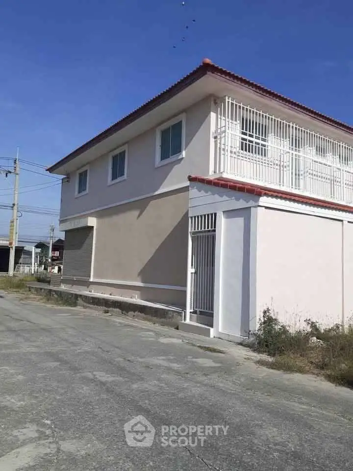 Charming two-story house with gated entrance and spacious exterior, perfect for family living.