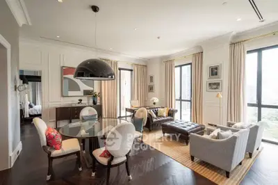 Luxurious living room with elegant decor and large windows offering city views.