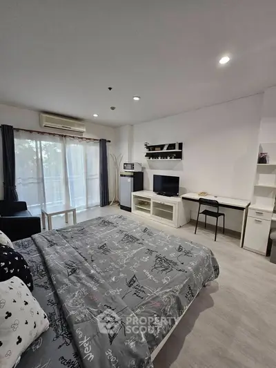 Modern studio apartment with cozy bedroom and living area, featuring a balcony and stylish decor.
