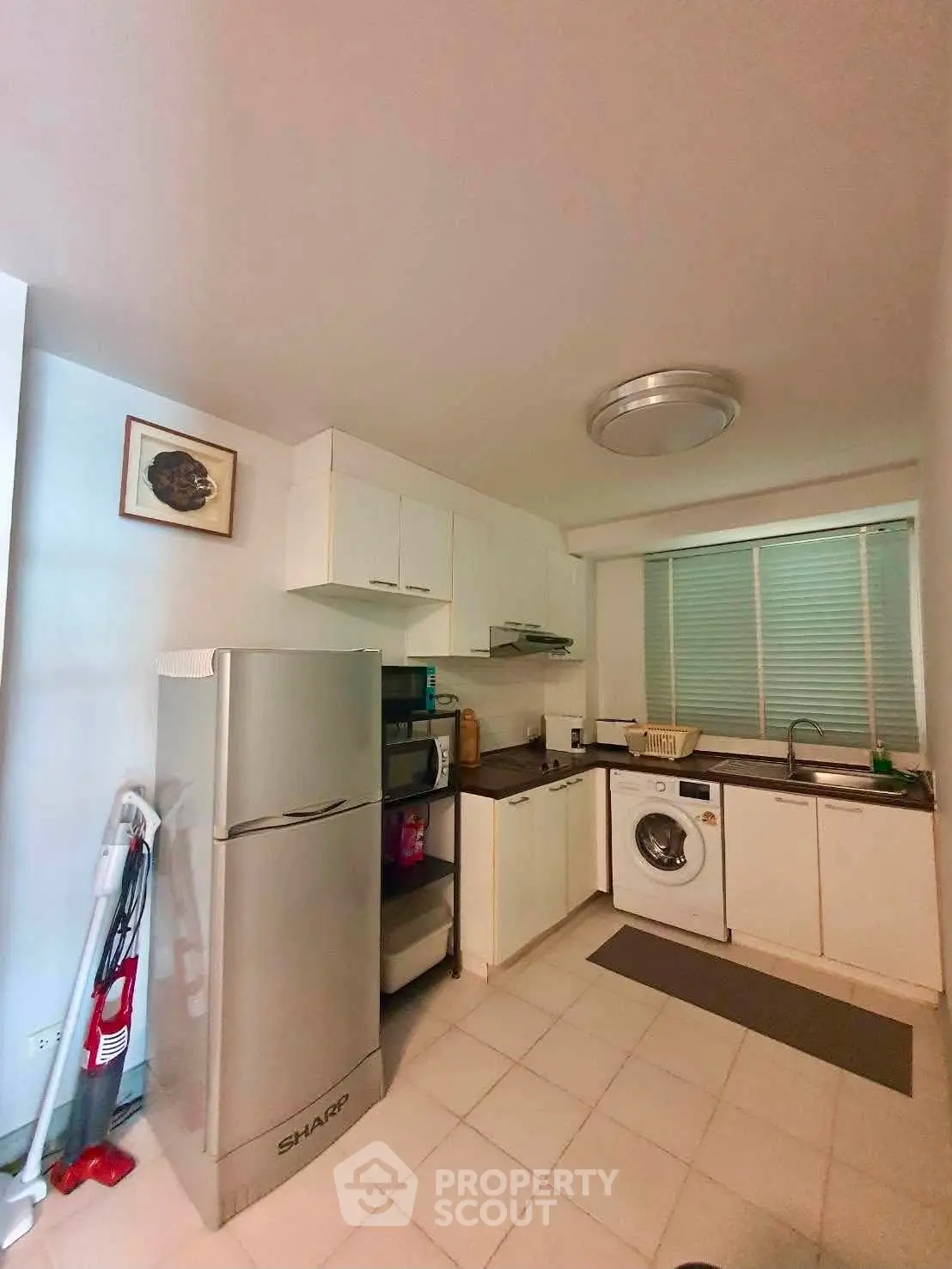 Cozy kitchen with modern appliances and washing machine in a compact layout