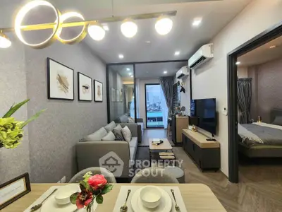 Modern living room with elegant decor and city view, featuring cozy seating and stylish lighting.