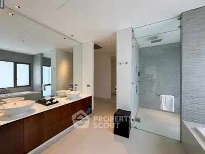 Luxurious modern bathroom with dual sinks and glass shower enclosure