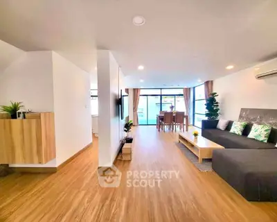 Spacious modern living room with wooden flooring and stylish decor