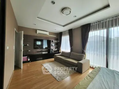 Spacious living room with modern decor and large windows for natural light.