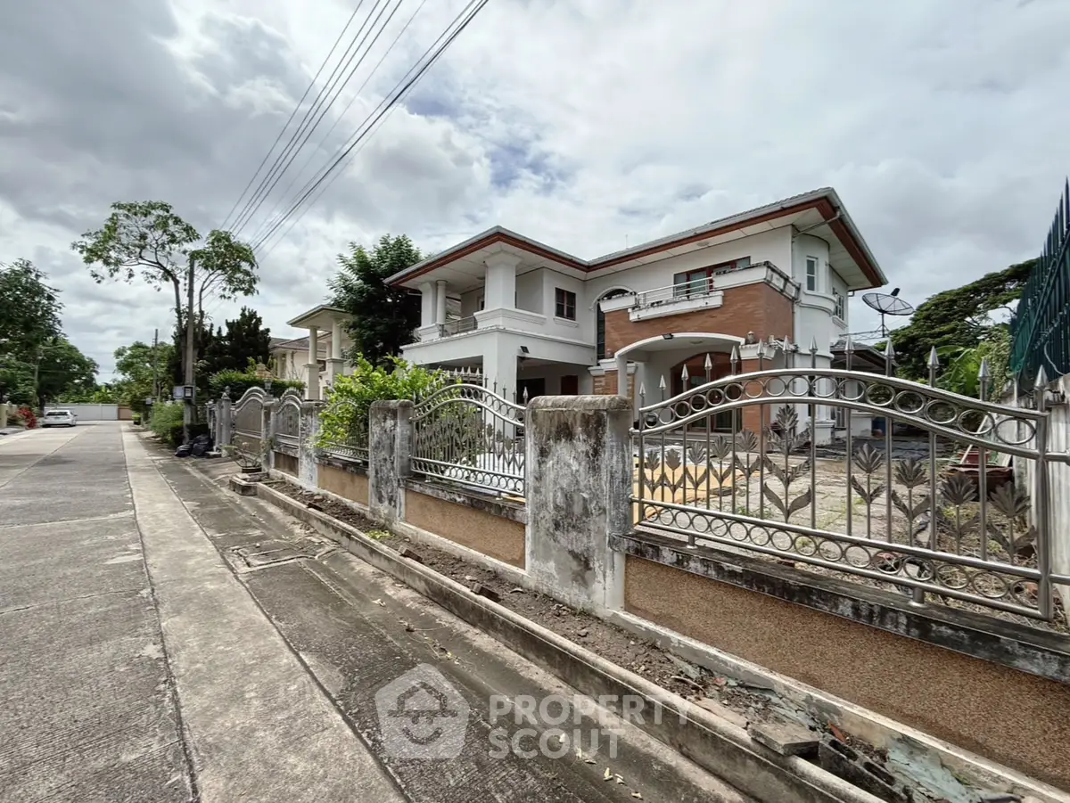 Charming suburban house with spacious front yard and elegant fencing