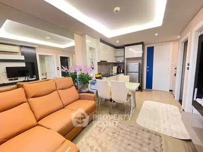 Modern open-layout living room with stylish kitchen and cozy seating area.
