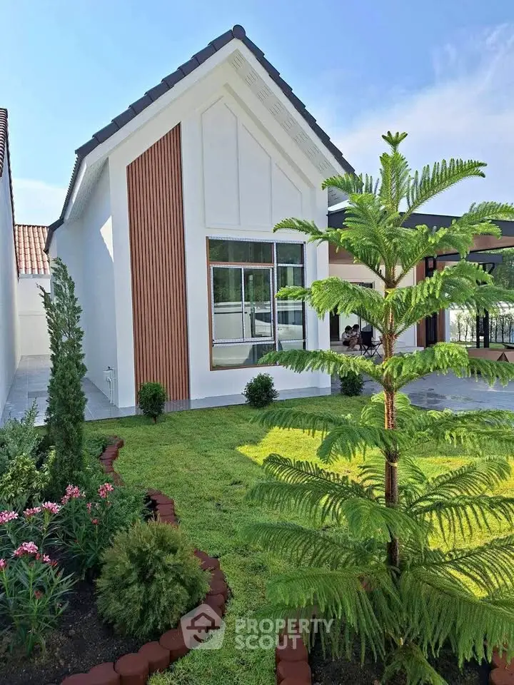 Charming modern house with lush garden and unique architectural design, perfect for serene living.