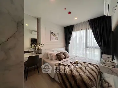 Luxurious bedroom with elegant decor and city view, featuring plush bedding and modern furnishings.