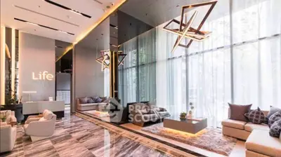 Luxurious modern living room with high ceilings and elegant lighting fixtures.