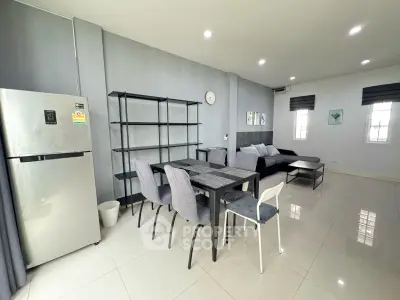 Modern open-plan living and dining area with sleek furniture and natural light.