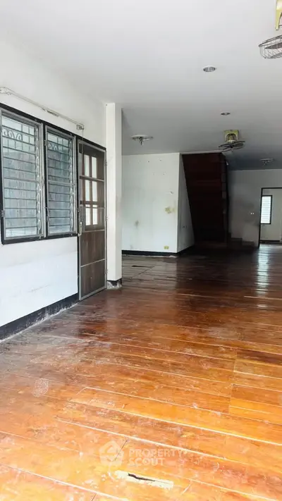 Spacious interior with wooden flooring and staircase, ideal for modern living.
