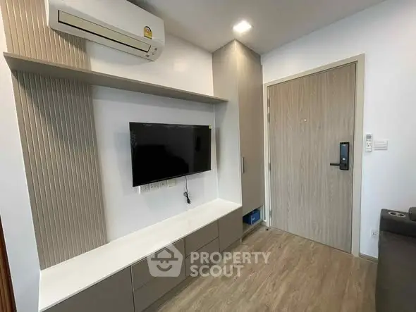 Modern living room with wall-mounted TV and air conditioning unit