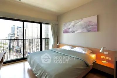 Modern bedroom with city view, featuring a cozy bed and stylish decor in a high-rise apartment.