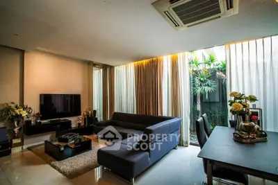 Luxurious modern living room with sleek furniture and large windows for natural light.