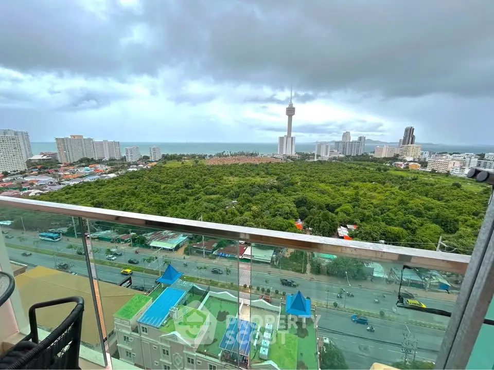 Stunning high-rise balcony view overlooking lush greenery and cityscape