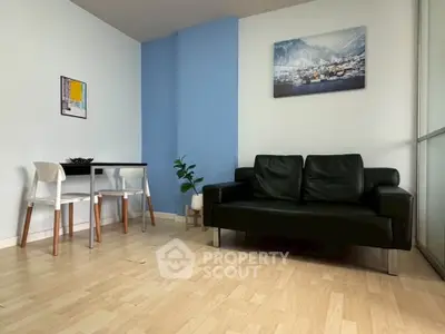 Modern living room with black sofa, dining table, and stylish decor