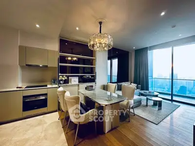 Luxurious open-plan living room with modern kitchen and stunning city view.