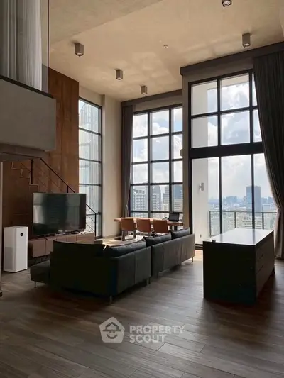 Luxurious modern living room with floor-to-ceiling windows and stunning city view.