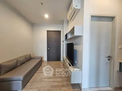 Modern living room with sleek design, featuring a comfortable sofa and wall-mounted TV unit.
