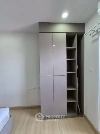 Modern bedroom with sleek built-in wardrobe and wooden flooring